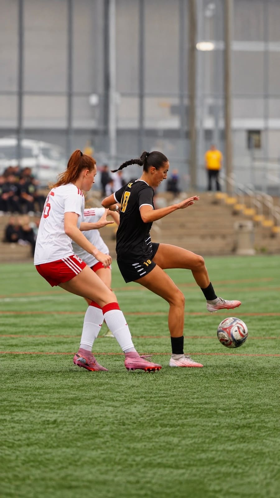 Arianna Rushenas turning with the ball past a defender for the Dalhousie Tigers